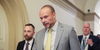 Dan Bongino walks in the Capitol.