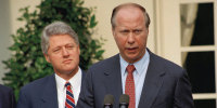 President Clinton listens to David Gergen during a Rose Garden news conference 