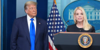 Attorney General Pam Bondi speaks to reporters as President Donald Trump listens.