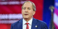 Ken Paxton gestures while speaking.