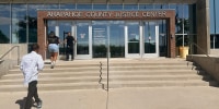 People enter the Arapahoe County Justice Center in Centennial, Colo., on July 14, 2025. 