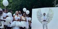 Jabari Peoples family members hold balloons