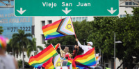 Participants waves pride flags on their way to Old San Juan.