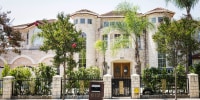 A large mansion on Camino Real Avenue as seen from the street