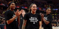  Kiki Iriafen #44 of the Washington Mystics, Gabby Williams #5 of the Seattle Storm, Jackie Young #0 of the Las Vegas Aces, Sonia Citron #2 of the Washington Mystics and Brittney Sykes #15 of the Washington Mystics wear shirts saying "Pay us what you owe us" prior to the WNBA All-Star Game on July 19, 2025 in Indianapolis, . 