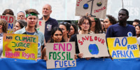 Climate activits hold signs outside
