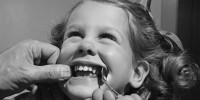 A little girl has her teeth checked by a dentist 