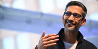 Sundar Pichai, smiles while speaking.