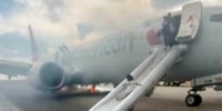 Passengers flee smoking jet on emergency slide after apparent landing gear problem at Denver airport