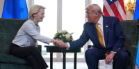 President Donald Trump and European Commission President Ursula von der Leyen shake hands.