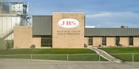 A JBS building exterior with the local on the front facing brick wall