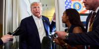 Donald Trump speaks to reporters inside of a plane