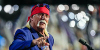 Hulk Hogan speaks on stage while pointing