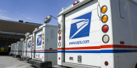 Image: Row of USPS delivery trucks