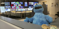 Image: A stuffed Cookie Monster is seated in a control room at the Arizona PBS offices in Phoenix.