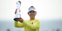 Miyu Yamashita holds up her trophy and smiles outside