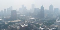 Aerial view of a blanket of smoke filling the air above buildings