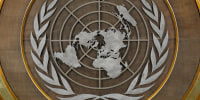 The United Nations logo on a wall