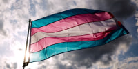  A transgender rights activist holds a flag