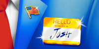 Close-up of suit with an American flag lapel pin and a golden "Hello My Name Is" tag with "JOSH" written on it.