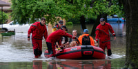 Residents in boats during flooding.