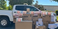 Boxes of Labubu dolls are displayed in front of a white truck outside on the street