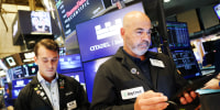 Traders work on the floor of the NYSE