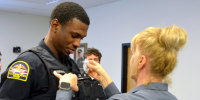 Officer Jon Luke Evans receives his police badge.