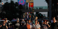 Visitors walk along the Las Vegas Strip 
