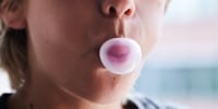 A child chews gum.