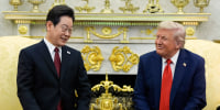 Lee Jae Myung, left, and Donald Trump sit in chairs in the Oval Office