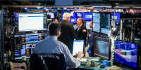 Traders work on the floor at the New York Stock Exchange