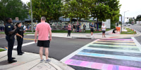 Orlando Police officers warn people not to apply chalk to the crosswalk outside of the Pulse Interim Memorial,