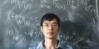 Mathematician Terry Tao stood in front of a blackboard