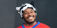 LaRussell smiles while performing onstage