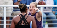 Jelena Ostapenko pointing at Taylor Townsend, who's back is facing the camera