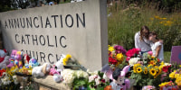 People visit a memorial outside of Annunciation Catholic Church on Aug. 29, 2025 in Minneapolis.