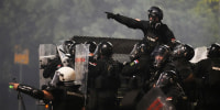 Serbian gendarmerie officers patrol in truck after clearing people blocking a street during an anti-government protest in Belgrade, Serbia, Saturday, Aug. 16, 2025. 