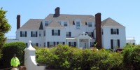 Image: People walk past a house owned by Taylor Swift in the village of Watch Hill in Westerly, R.I.
