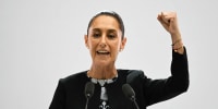Mexico's President Claudia Sheinbaum raises her fist as she delivers her first State of the Nation Address at Palacio Nacional in Mexico City.