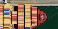 Cargo containers line a ship 