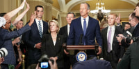 Reporters ask John Thune questions at a news conference.