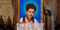 An image of 15-year-old Carlo AcutiS is unveiled during his beatification ceremony at St. Francis Basilica in 2020.