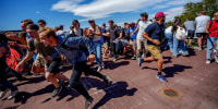 People run after a shot was fired at U.S. right-wing activist and commentator Charlie Kirk at a Utah Valley University speaking event in Orem