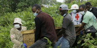 Image: congo red cross volunteers carry coffin burial ceremony