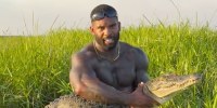 Mike Holston, aka @therealtarzann wrestles with a saltwater crocodile in a recent Instagram post. 