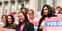 Tori Schafer, an attorney with the ACLU of Missouri, stands on the steps of the Missouri Capitol while surrounded by members of Missourians for Constitutional Freedom following a Missouri Supreme Court ruling that kept Amendment 3 on the ballot last year.
