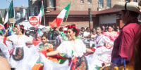 Women dance in a parade crowd