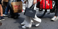 Pedestrians carry shopping bags in New York, on Sept. 6, 2025. 