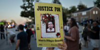 A person holds a sign in memory of Silverio Villegas Gonzalez